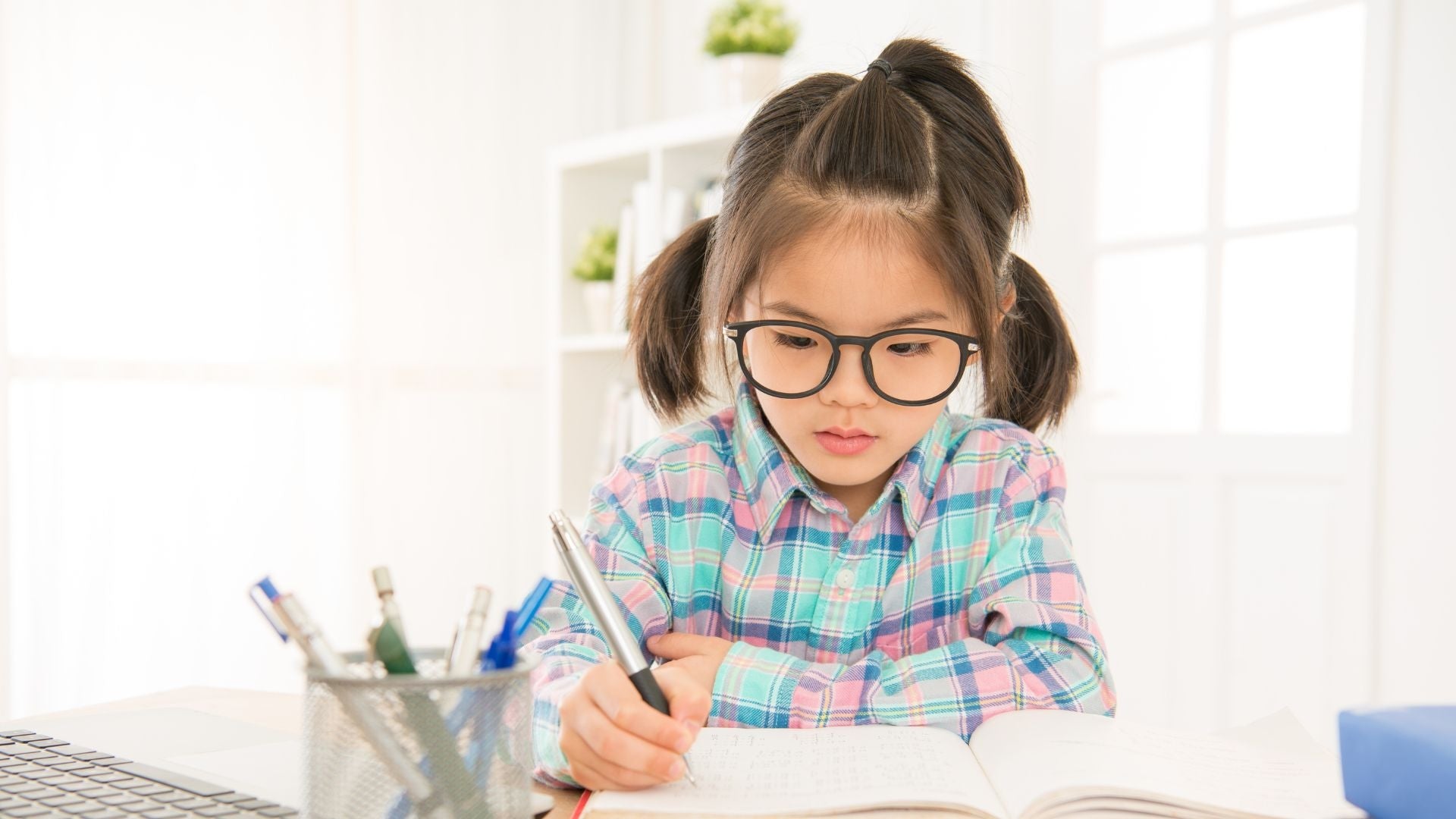 girl writing something on her kids journal